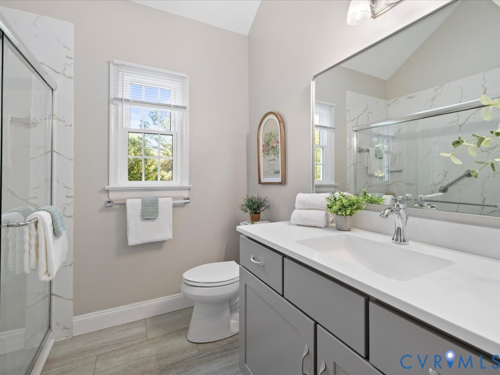 5309 Rock Harbour Road Midlothian, VA 23112 - Photo 24 of 47 a bathroom with a granite countertop sink mirror vanity and toilet