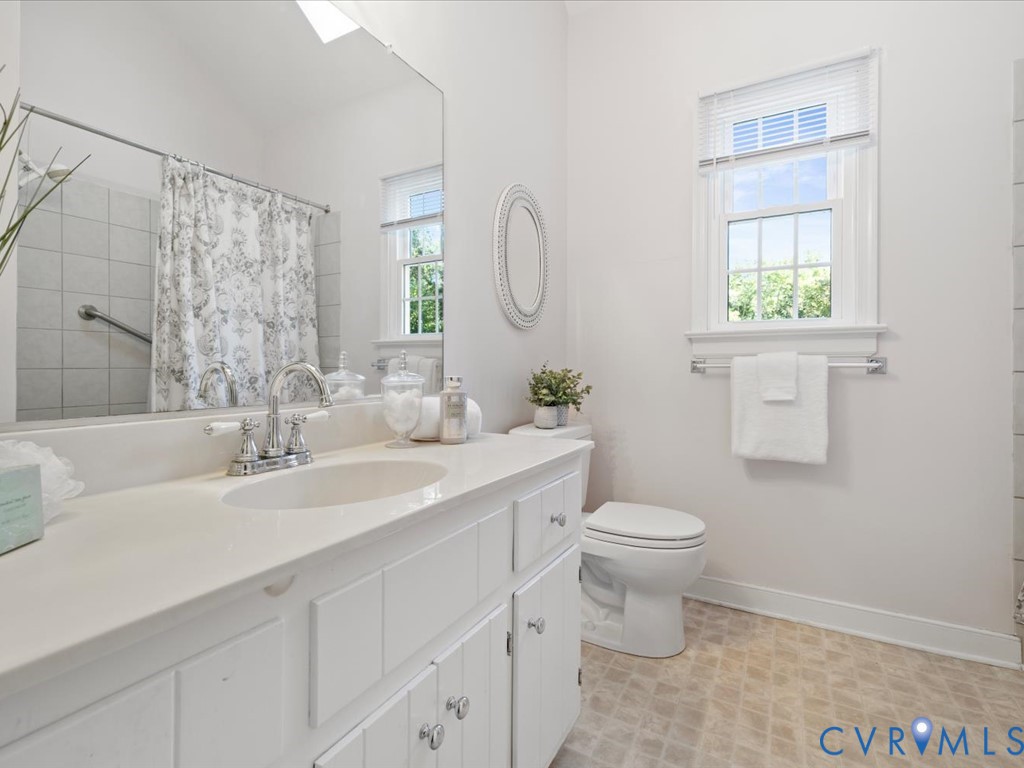 5309 Rock Harbour Road Midlothian, VA 23112 - Photo 30 of 47 a bathroom with a granite countertop toilet a sink and a mirror
