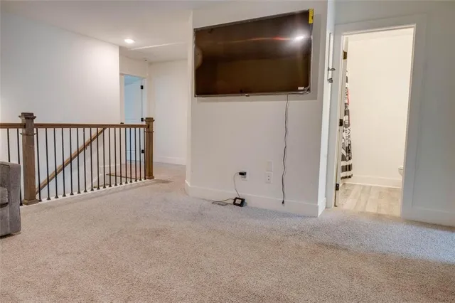 a view of a livingroom with a projector and stairs