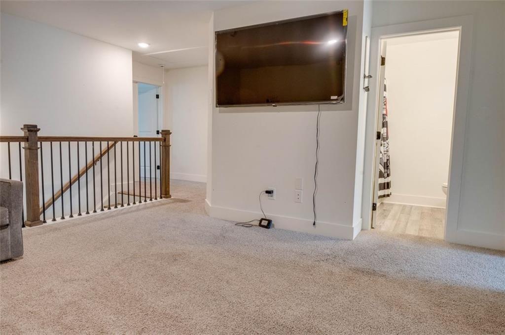 7621 Avalon Boulevard Fairburn, GA 30213 - Photo 11 of 25 a view of a livingroom with a projector and stairs