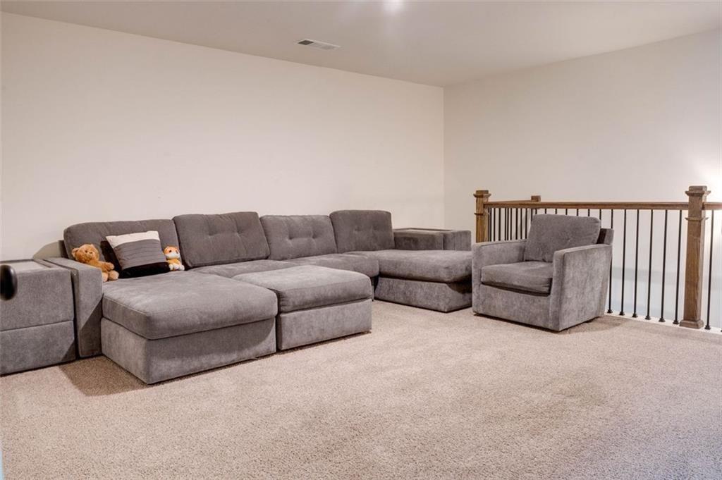 7621 Avalon Boulevard Fairburn, GA 30213 - Photo 12 of 25 a living room with furniture and a couch