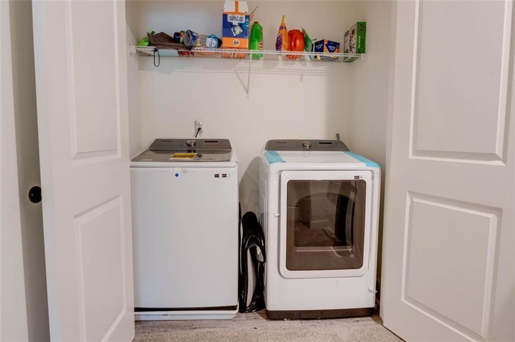 7621 Avalon Boulevard Fairburn, GA 30213 - Photo 14 of 25 a utility room with dryer and washer