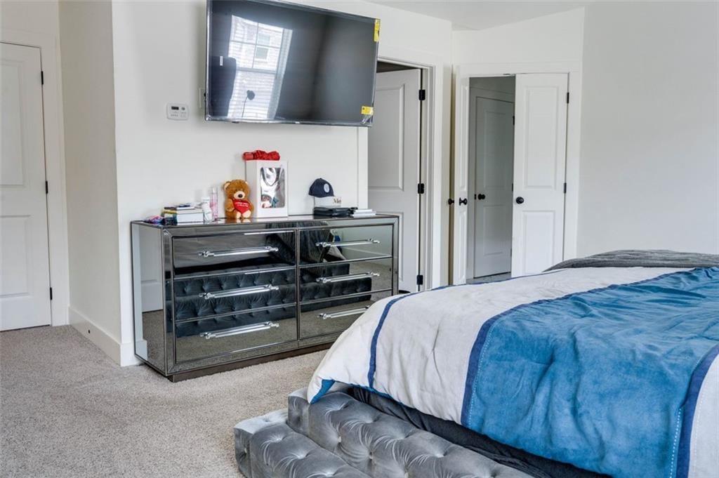 7621 Avalon Boulevard Fairburn, GA 30213 - Photo 15 of 25 a bedroom with a bed and a dresser