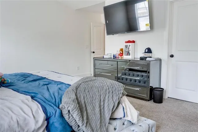 a bedroom with a bed and a mirror