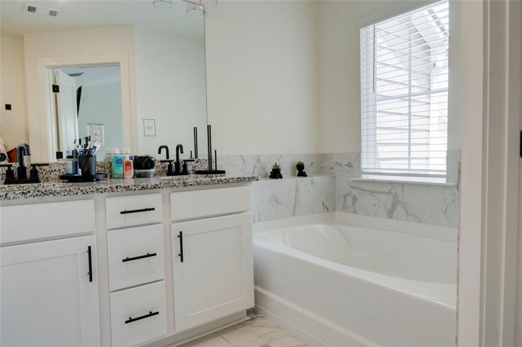 7621 Avalon Boulevard Fairburn, GA 30213 - Photo 19 of 25 a bathroom with sink bathtub and mirror
