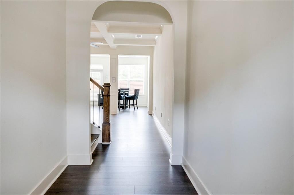 7621 Avalon Boulevard Fairburn, GA 30213 - Photo 2 of 25 wooden floor in a hall with a window