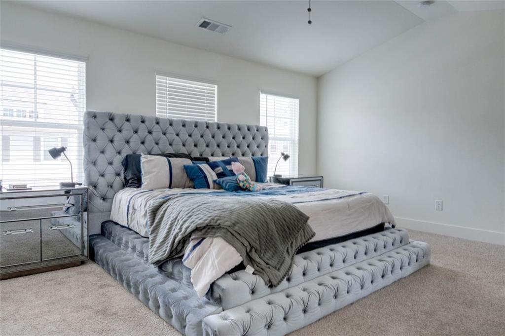 7621 Avalon Boulevard Fairburn, GA 30213 - Photo 22 of 25 a bedroom with a bed and window