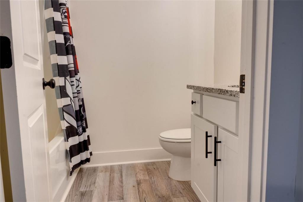 7621 Avalon Boulevard Fairburn, GA 30213 - Photo 23 of 25 a bathroom with a toilet and a shower