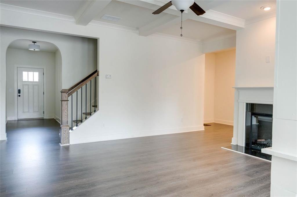 7621 Avalon Boulevard Fairburn, GA 30213 - Photo 3 of 25 a view of an empty room with wooden floor and a fire place