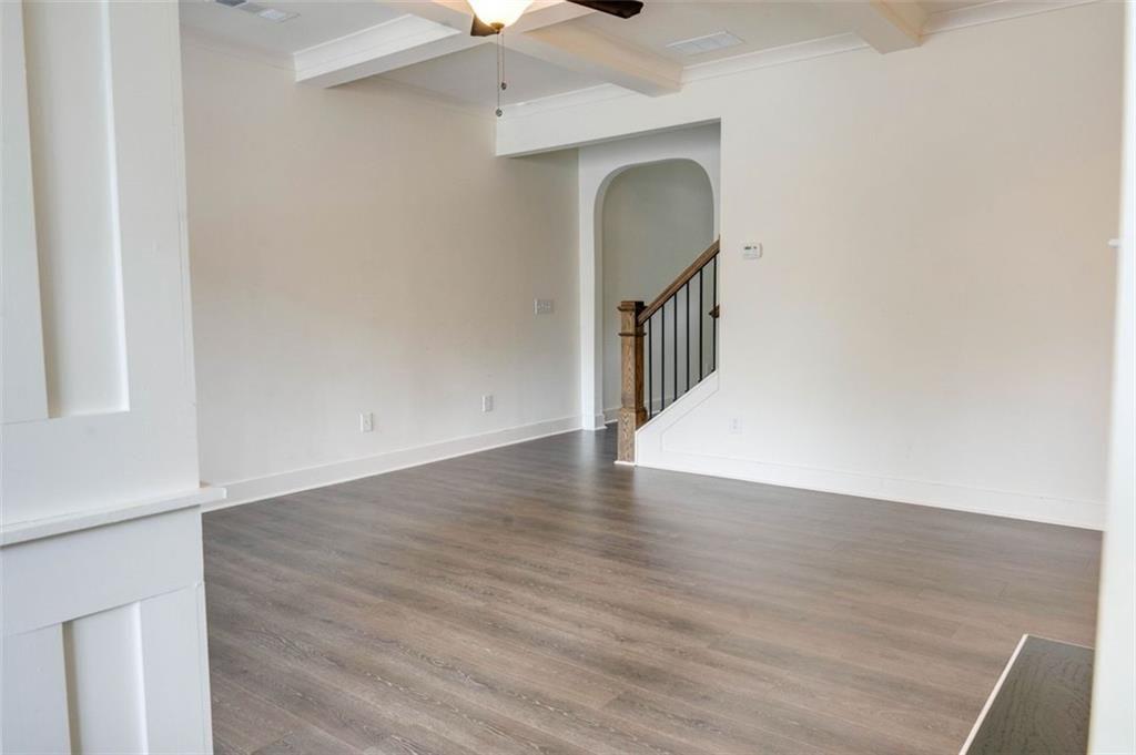 7621 Avalon Boulevard Fairburn, GA 30213 - Photo 5 of 25 a view of a hallway with wooden floor and a chandelier
