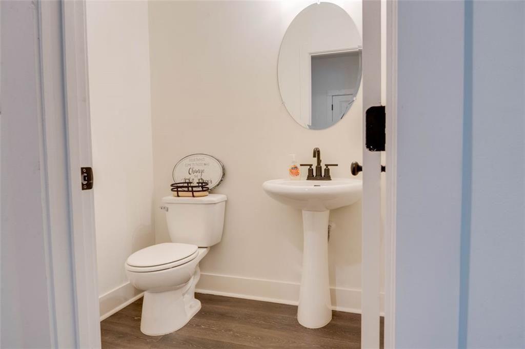 7621 Avalon Boulevard Fairburn, GA 30213 - Photo 6 of 25 a bathroom with a sink toilet and a mirror
