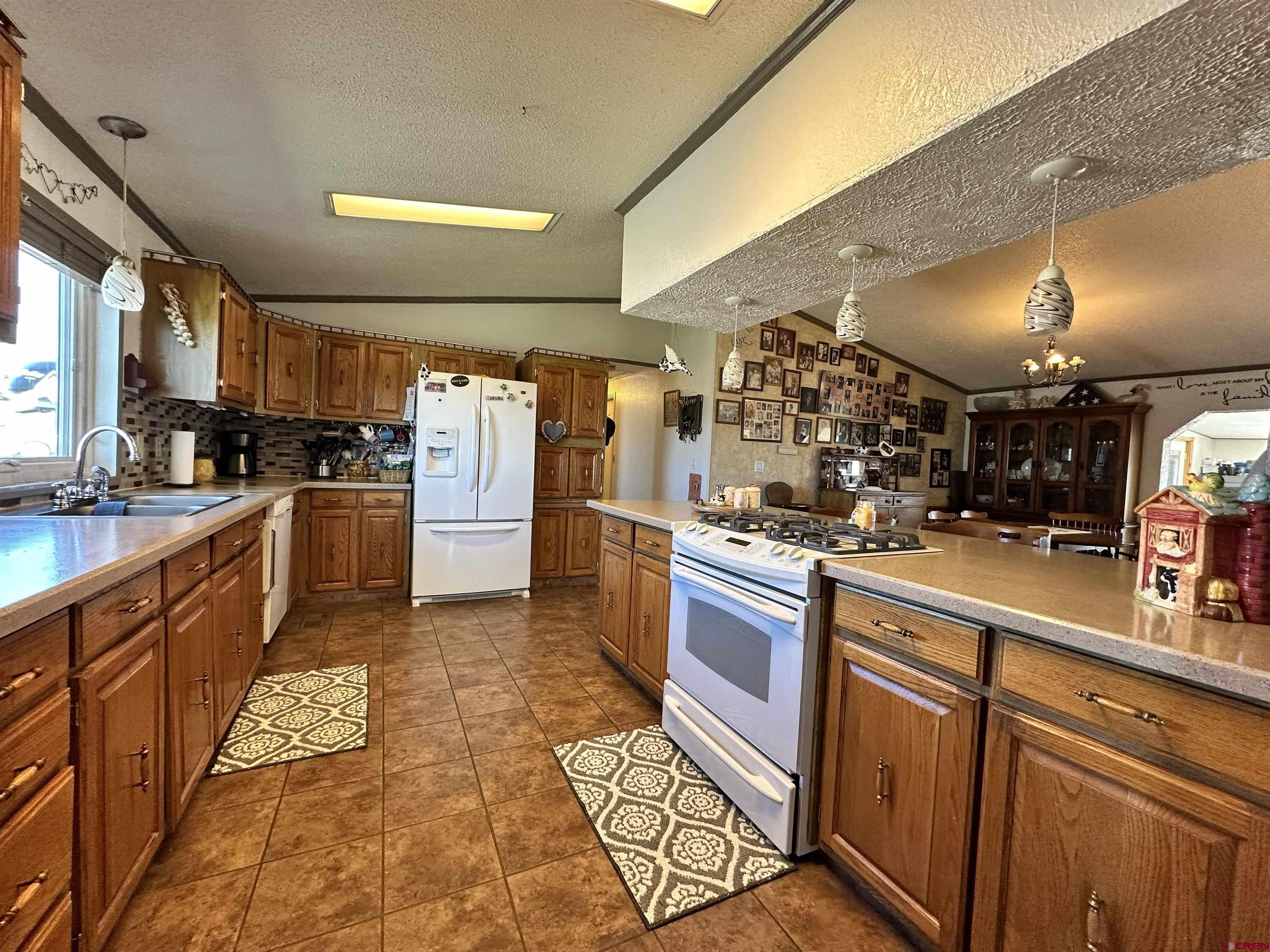 12880 2900th Road Hotchkiss, CO 81419 - Photo 8 of 22 a kitchen with stainless steel appliances granite countertop a sink and cabinets