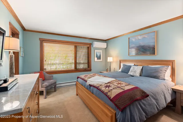 a bedroom with a bed and glass windows