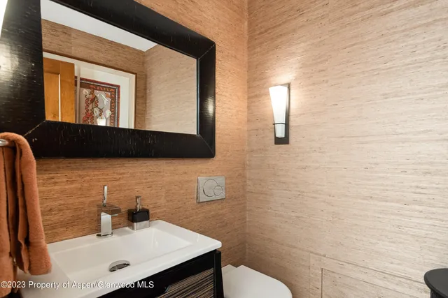 a bathroom with a sink a toilet and mirror