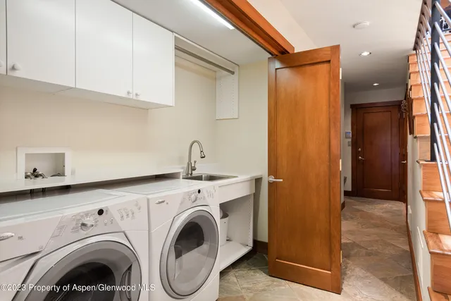 a view of storage and utility room with washer and dryer