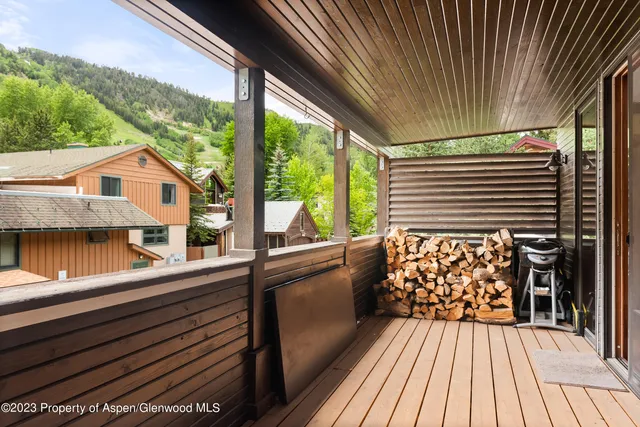 a view of balcony with wooden floor and fence