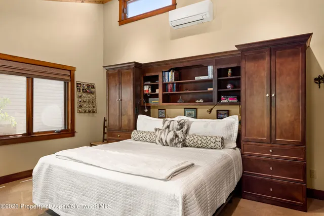 a bedroom with a large bed and a window