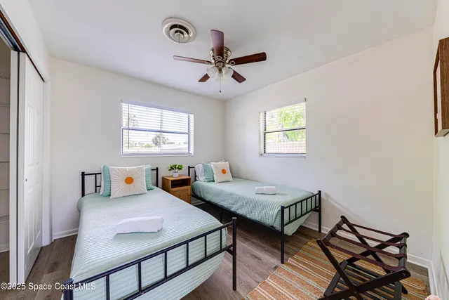 a bedroom with two beds and a window