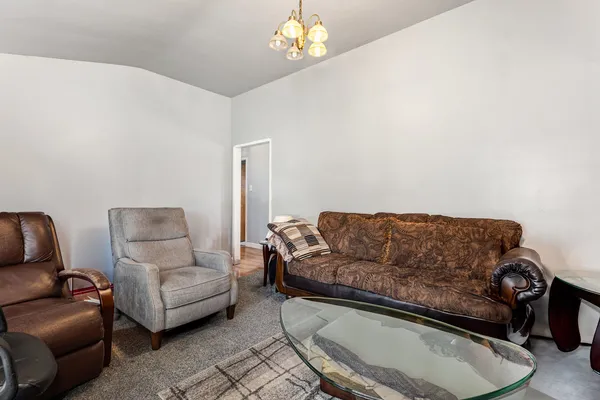 a living room with furniture and a chandelier