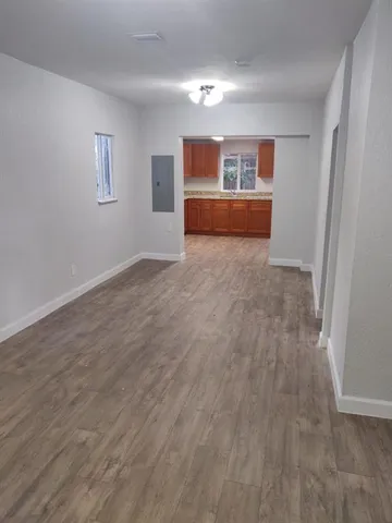 a view of empty room with wooden floor