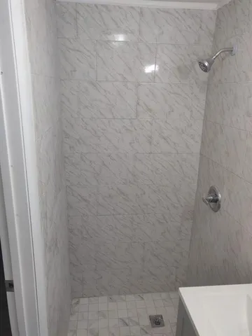 an empty room with wooden floor and mirror