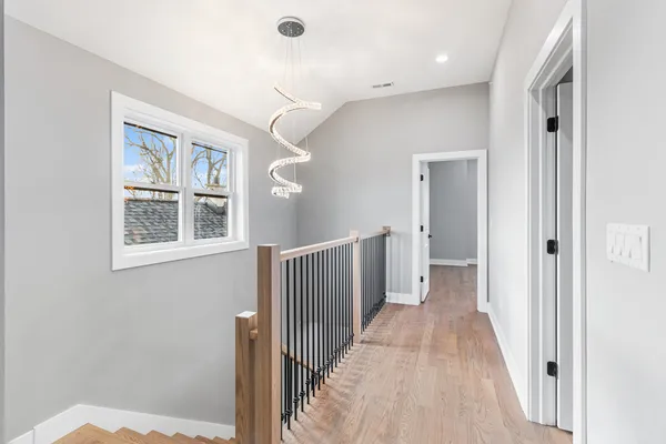 a view of a hallway with windows and stairs