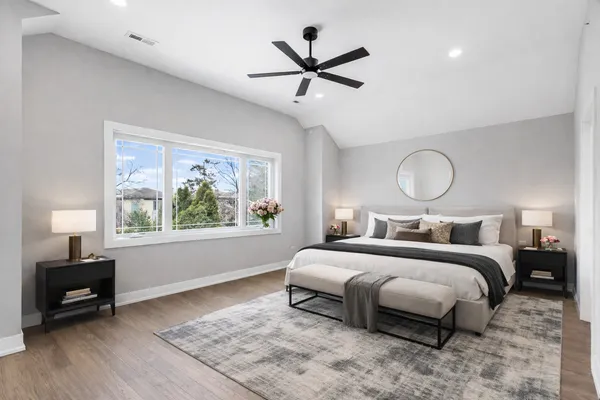 a bedroom with a bed and a chandelier