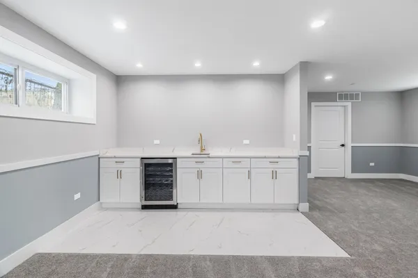 a view of an empty room with a kitchen