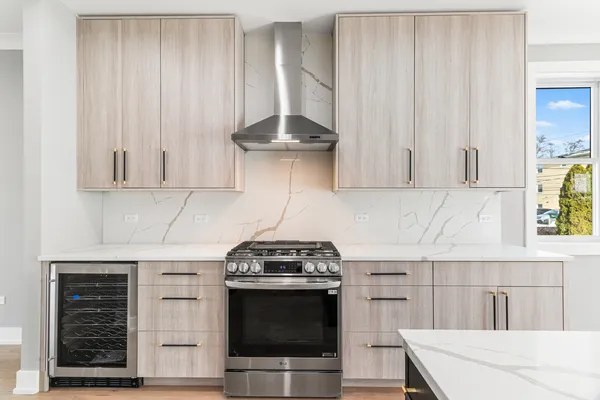 a kitchen with stainless steel appliances a stove a microwave and cabinets