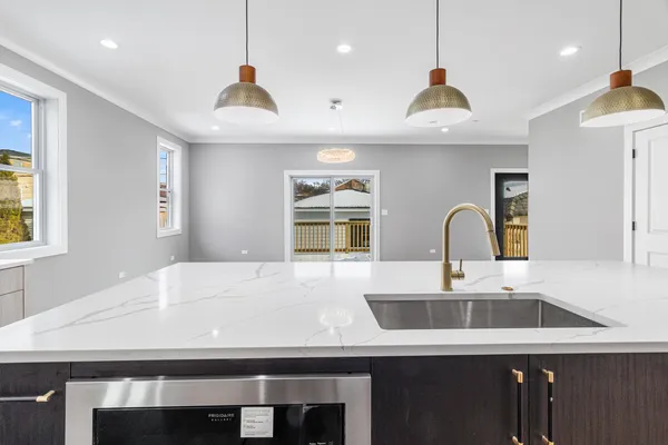 a kitchen with a sink a counter space and a refrigerator