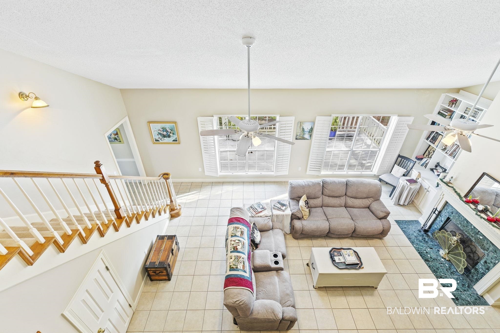 22 Pirates Lane Daphne, AL 36527 - Photo 18 of 36 Living room with a high end fireplace, light tile patterned floors, a textured ceiling, and ceiling fan