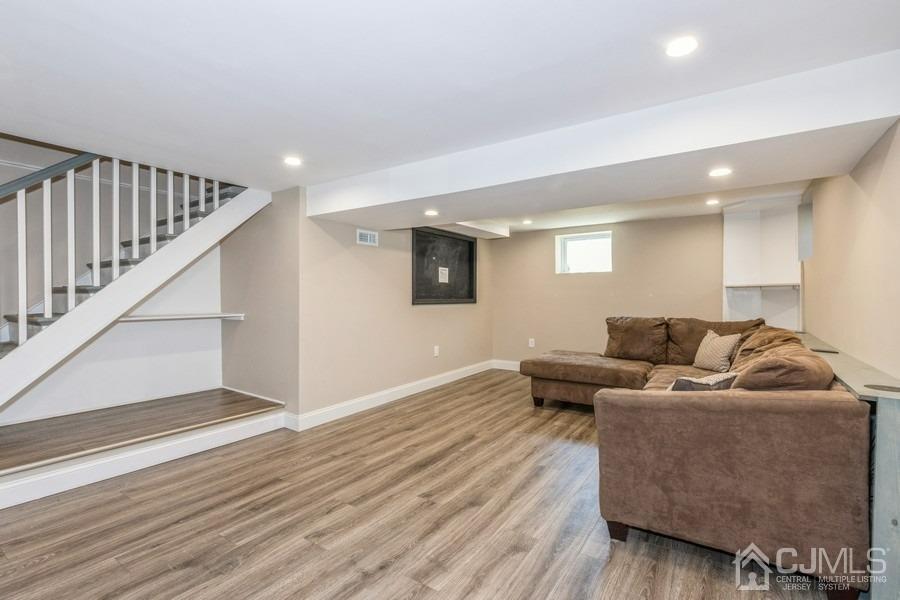 42 Montview Road Edison, NJ 08837 - Photo 22 of 27 a living room with furniture and a wooden floor