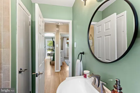 a bathroom with a mirror a sink and a mirror