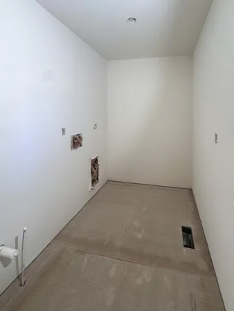 a view of an empty room with a fireplace and a window