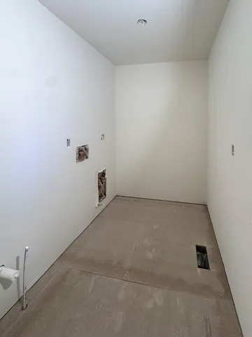 a view of an empty room with a fireplace and a window