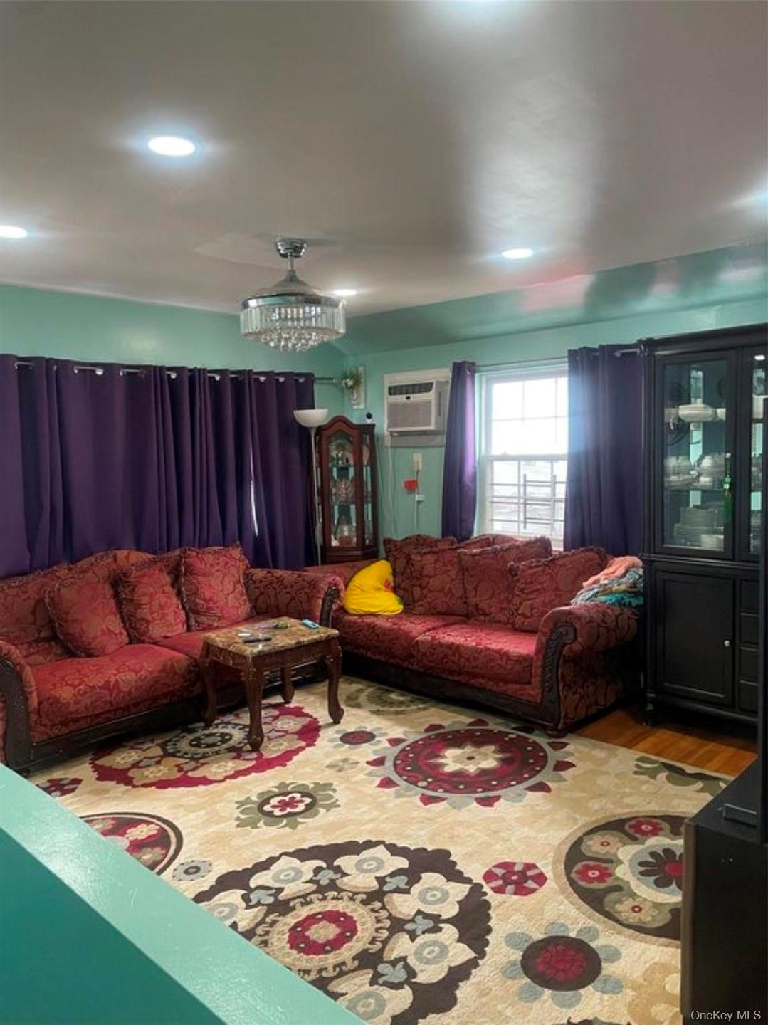 144-15 Lux Road Queens, NY 11435 - Photo 3 of 7 a living room with furniture and a rug