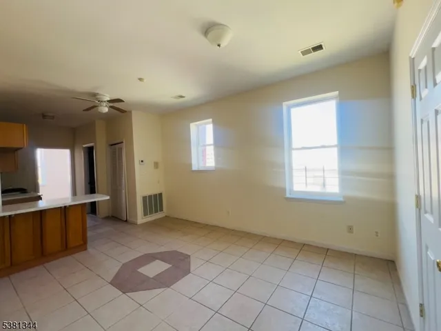 a view of a room with a fireplace and window