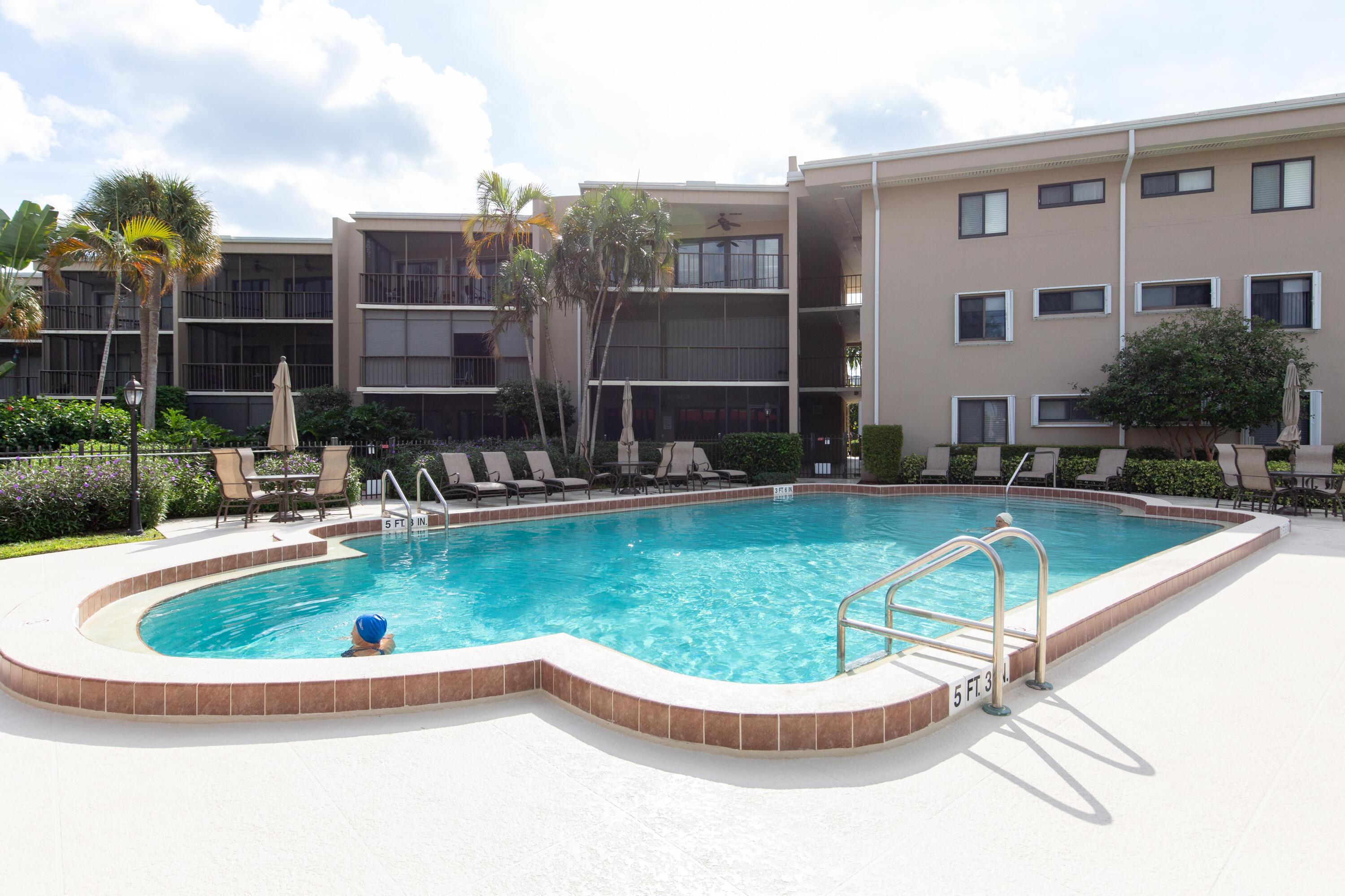 3605 South Ocean Boulevard South, Unit 103 South Palm Beach, FL 33480 - Photo 11 of 18 a view of a house with swimming pool and a yard