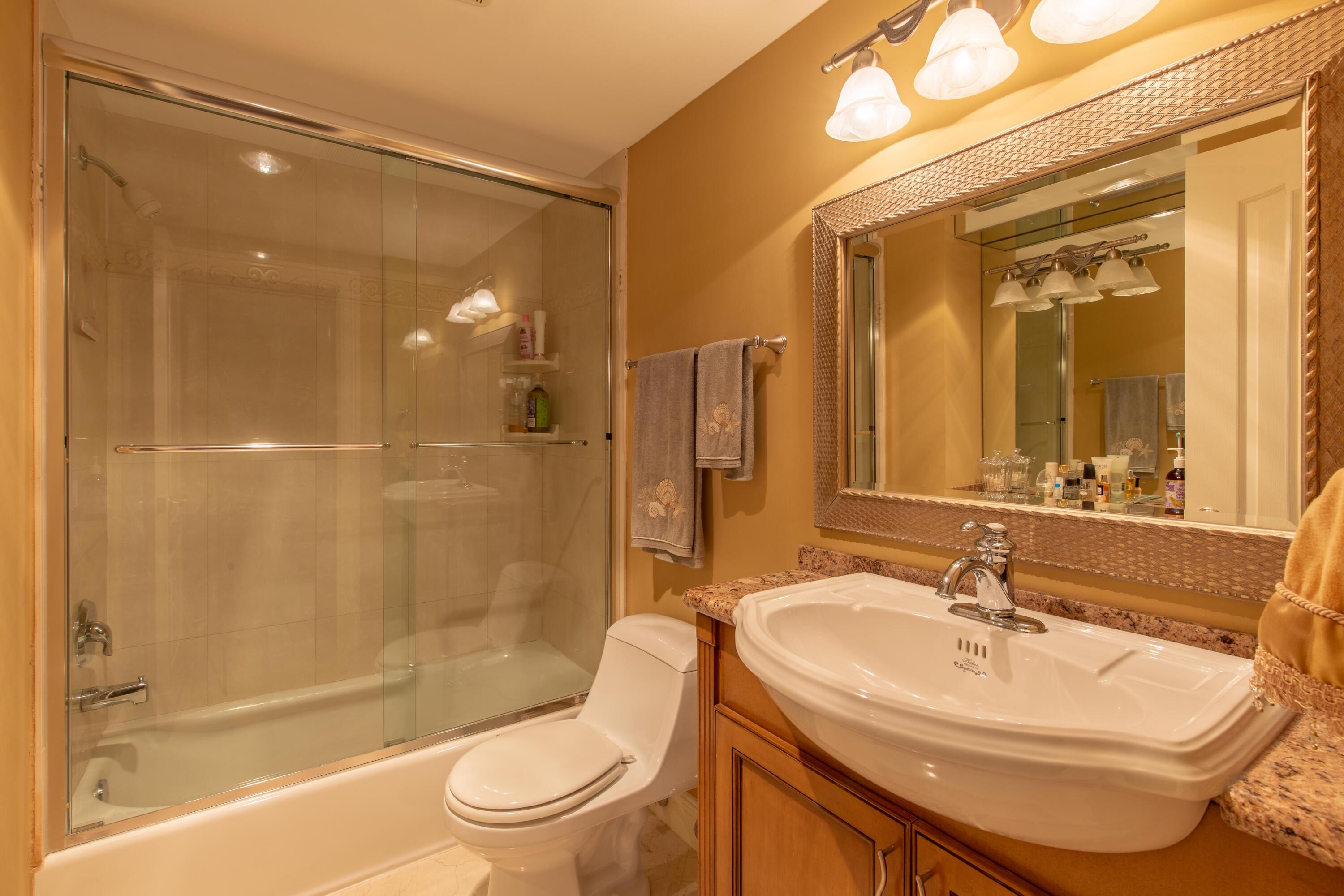 3605 South Ocean Boulevard South, Unit 103 South Palm Beach, FL 33480 - Photo 5 of 18 a bathroom with a sink and a mirror