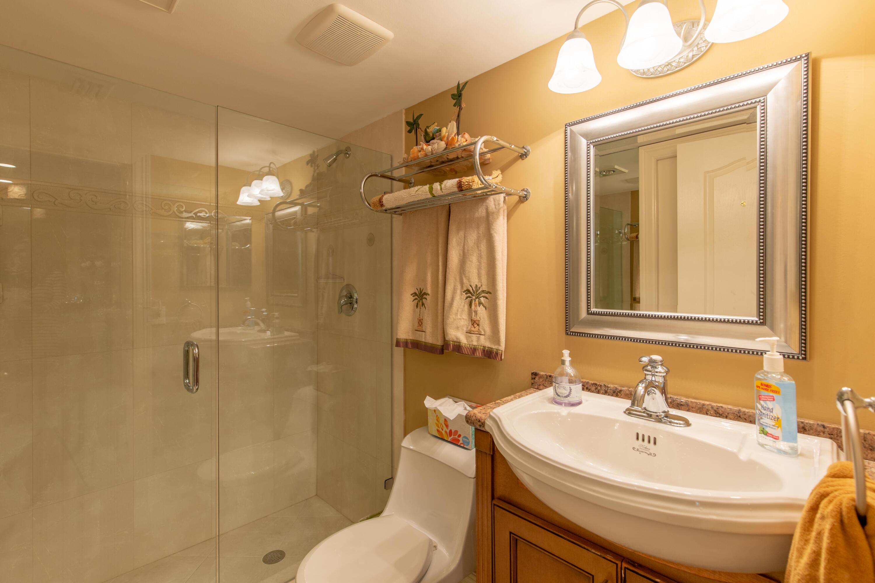 3605 South Ocean Boulevard South, Unit 103 South Palm Beach, FL 33480 - Photo 8 of 18 a bathroom with a sink a toilet and shower