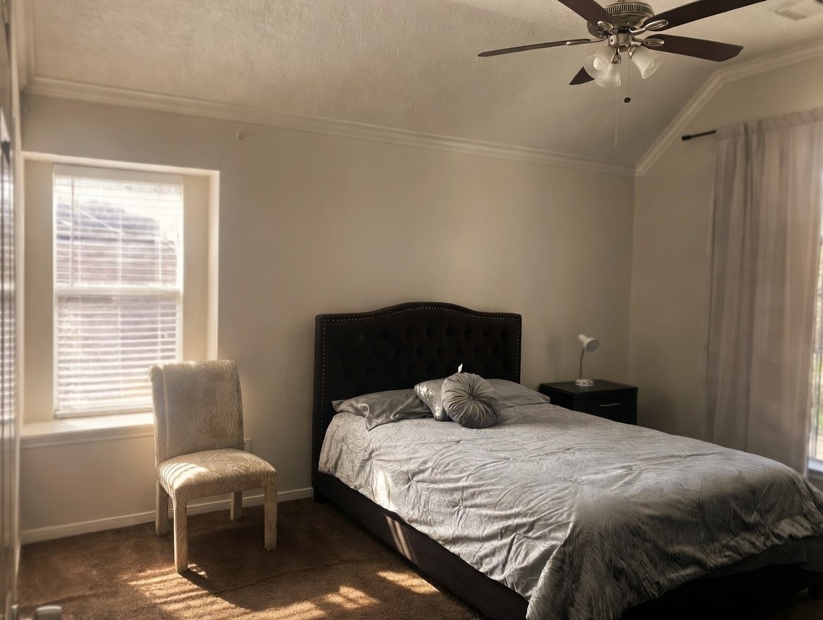 15922 Cutten Road Houston, TX 77070 - Photo 10 of 22 a bedroom with a bed and window