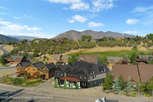 a view of a town with mountains in the background