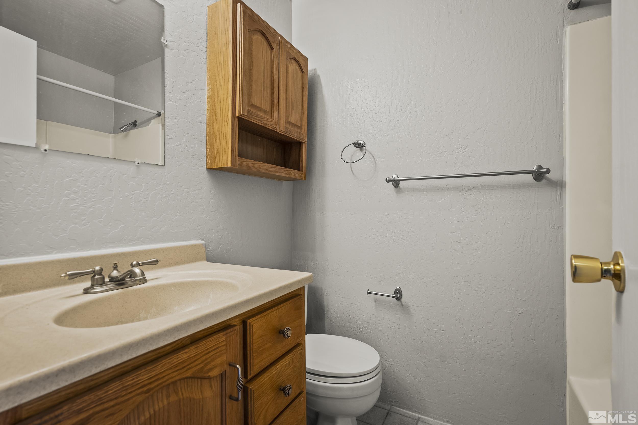 4694 Rio Poco Road Reno, NV 89502 - Photo 13 of 19 a bathroom with a sink toilet and vanity