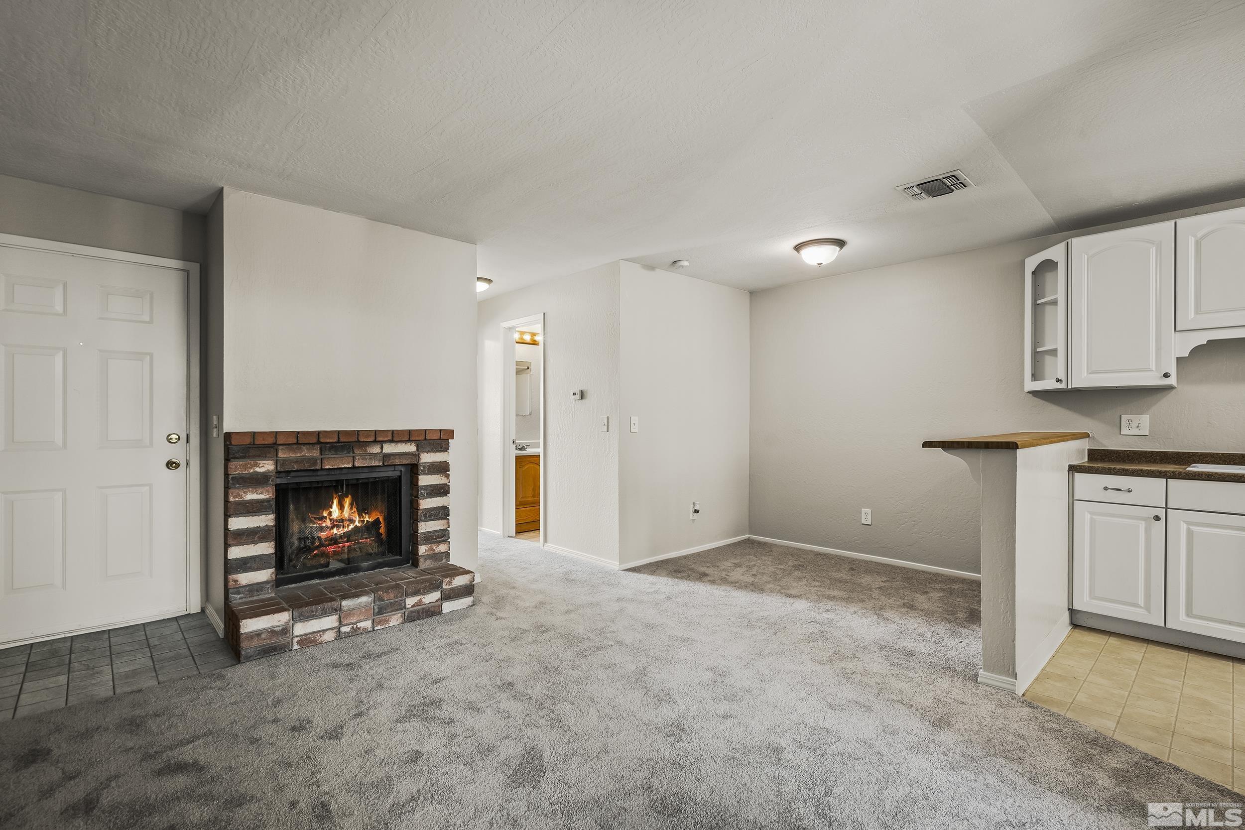 4694 Rio Poco Road Reno, NV 89502 - Photo 3 of 19 a view of an empty room with a fireplace