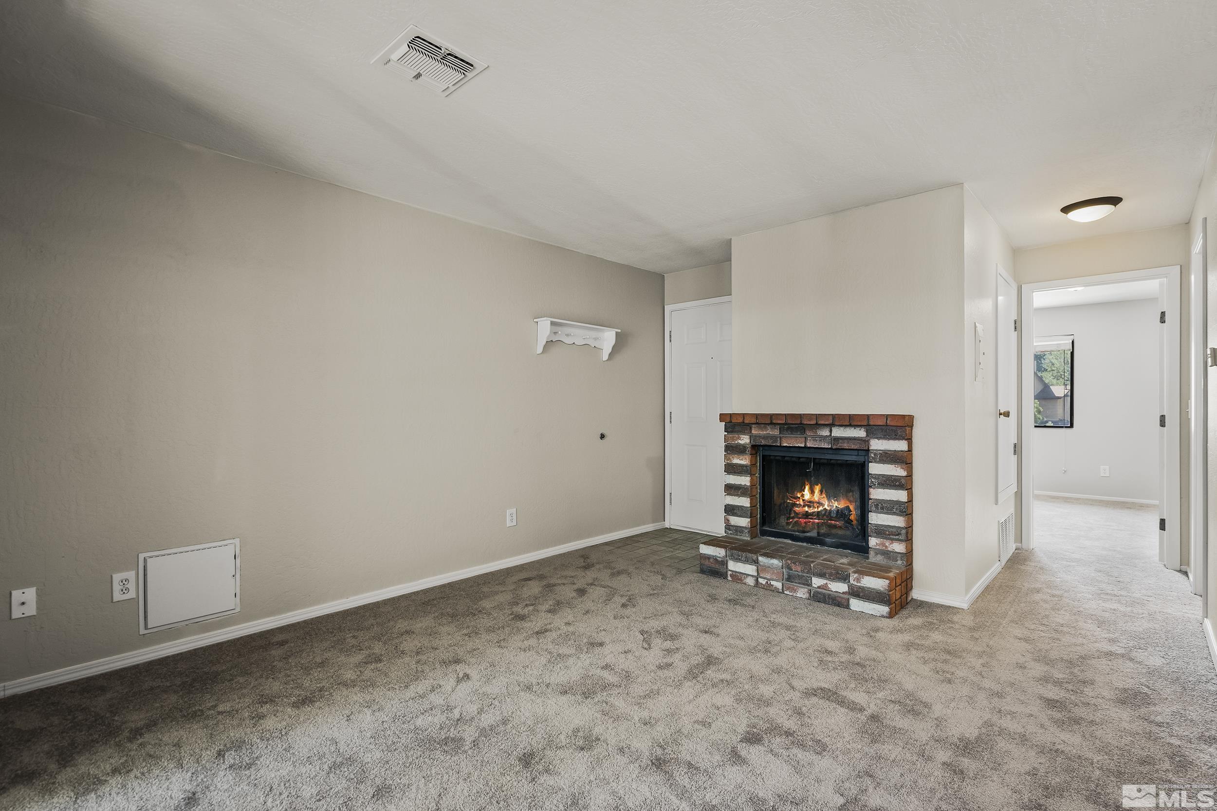 4694 Rio Poco Road Reno, NV 89502 - Photo 4 of 19 a view of an empty room with a fireplace
