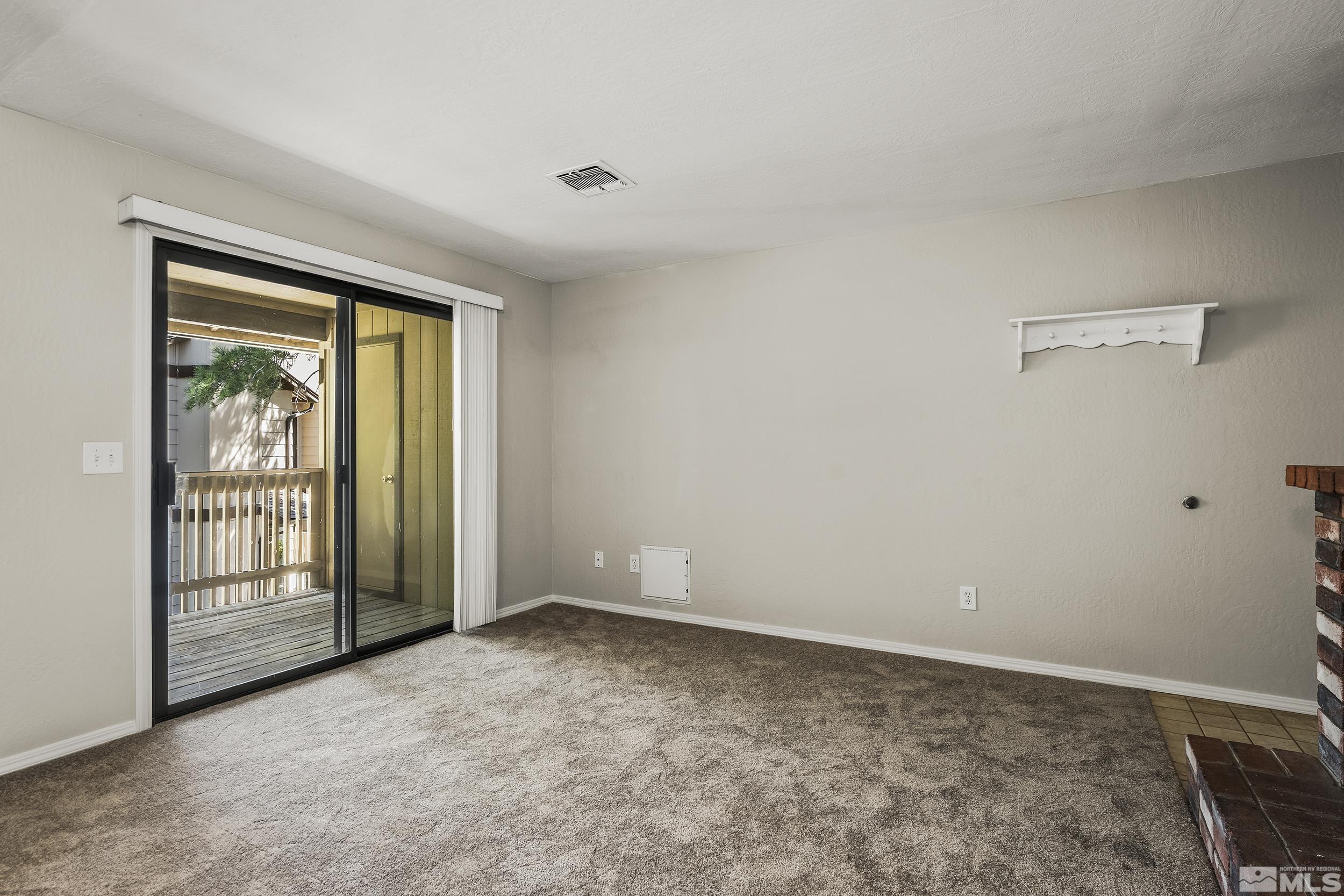4694 Rio Poco Road Reno, NV 89502 - Photo 5 of 19 a view of an empty room with a window