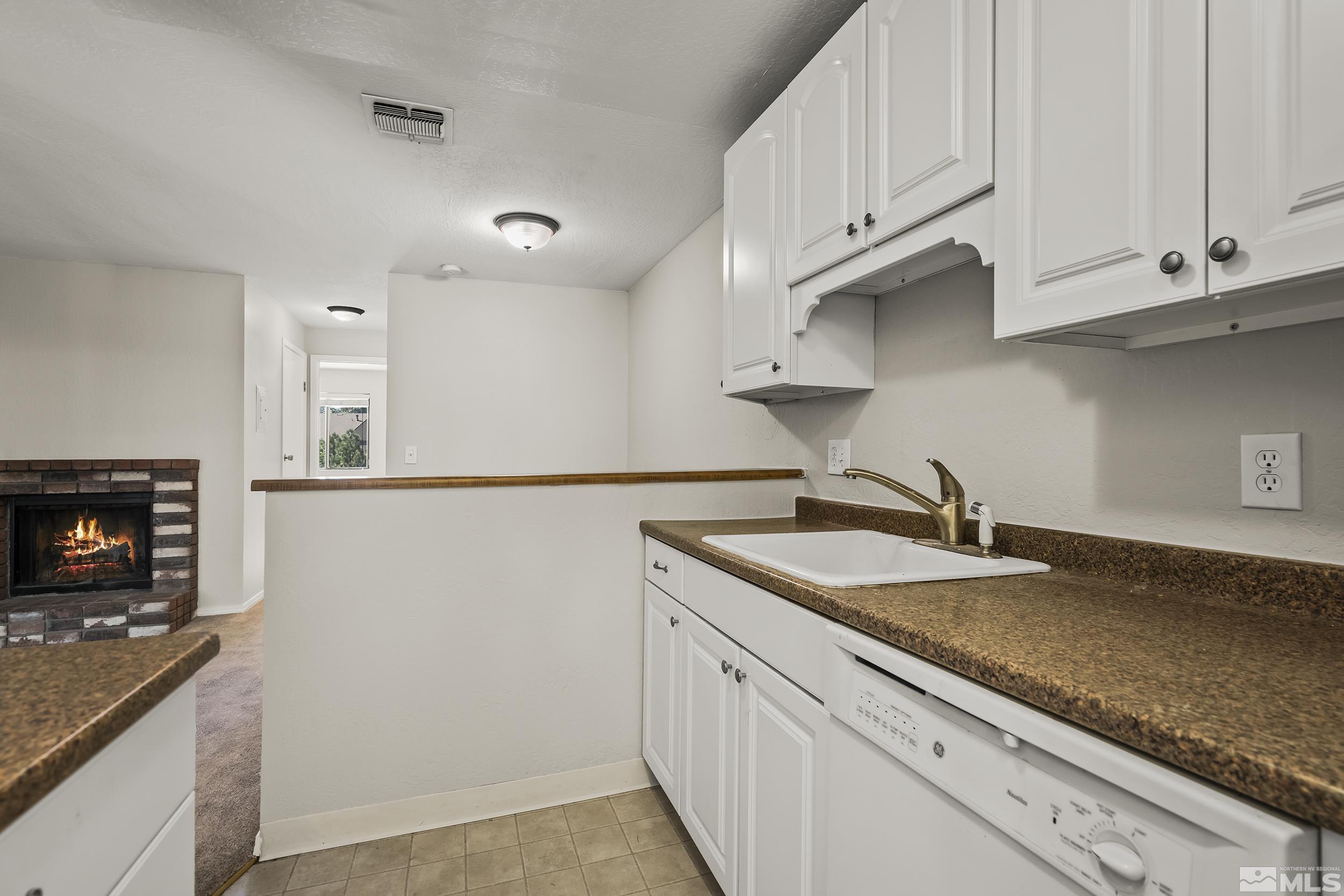 4694 Rio Poco Road Reno, NV 89502 - Photo 10 of 19 a kitchen with granite countertop a sink and a stove