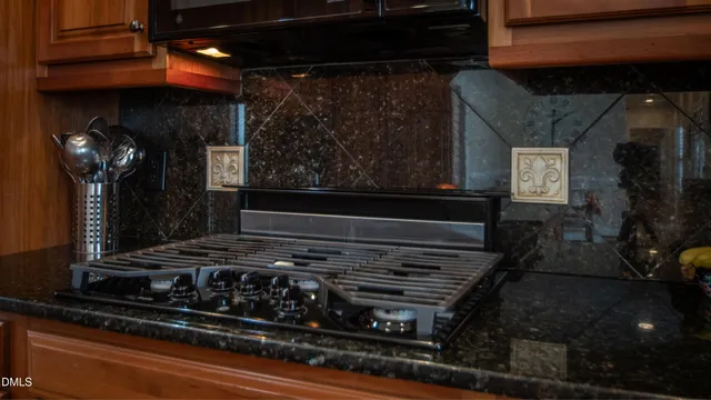 a stove top oven sitting inside of a kitchen