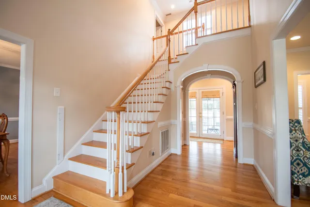 a view of entryway with wooden floor and staircase