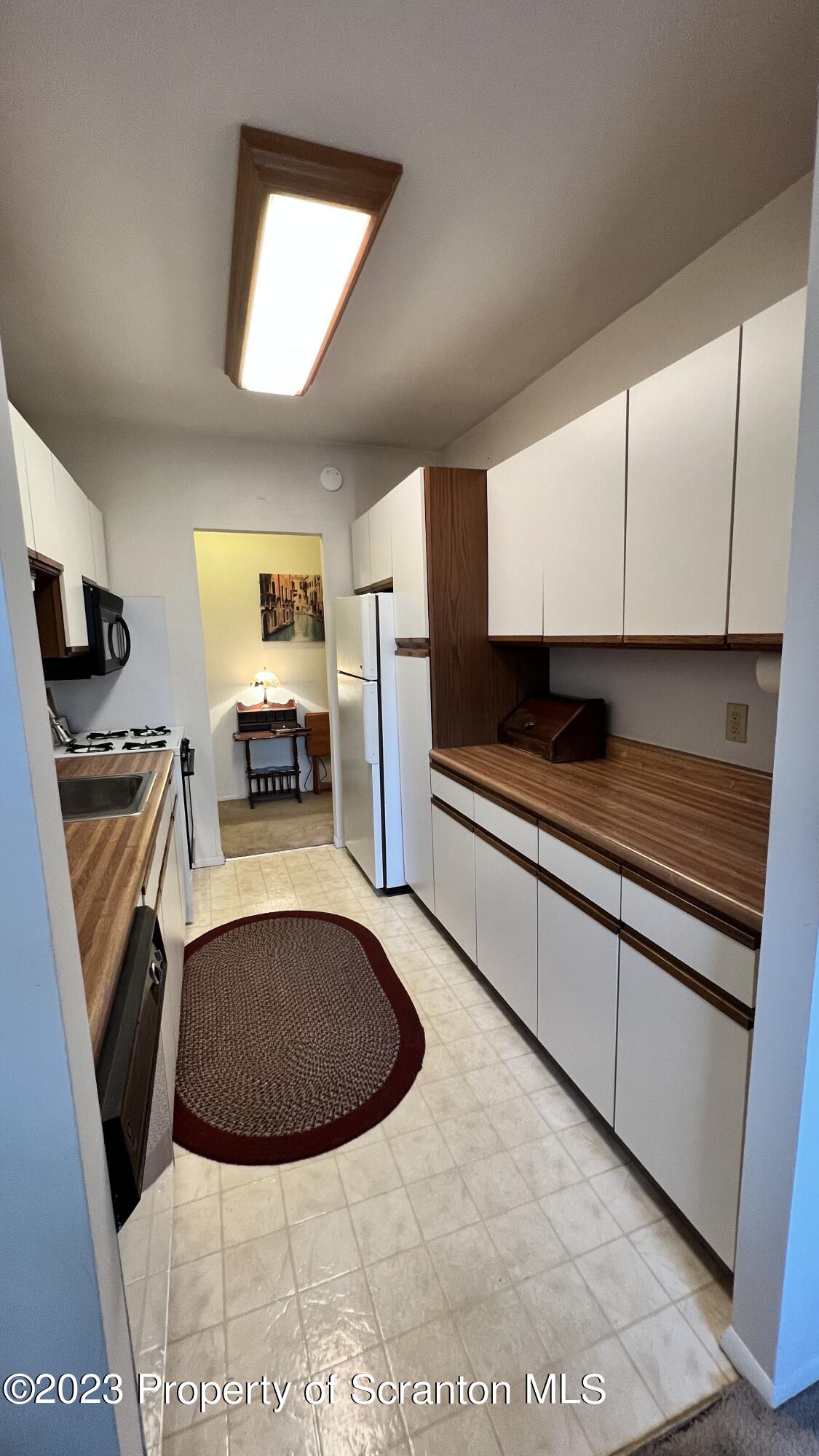 1410 Summit Point Route Scranton, PA 18508 - Photo 4 of 19 a view of a kitchen with stainless steel appliances granite countertop a stove a sink and a microwave